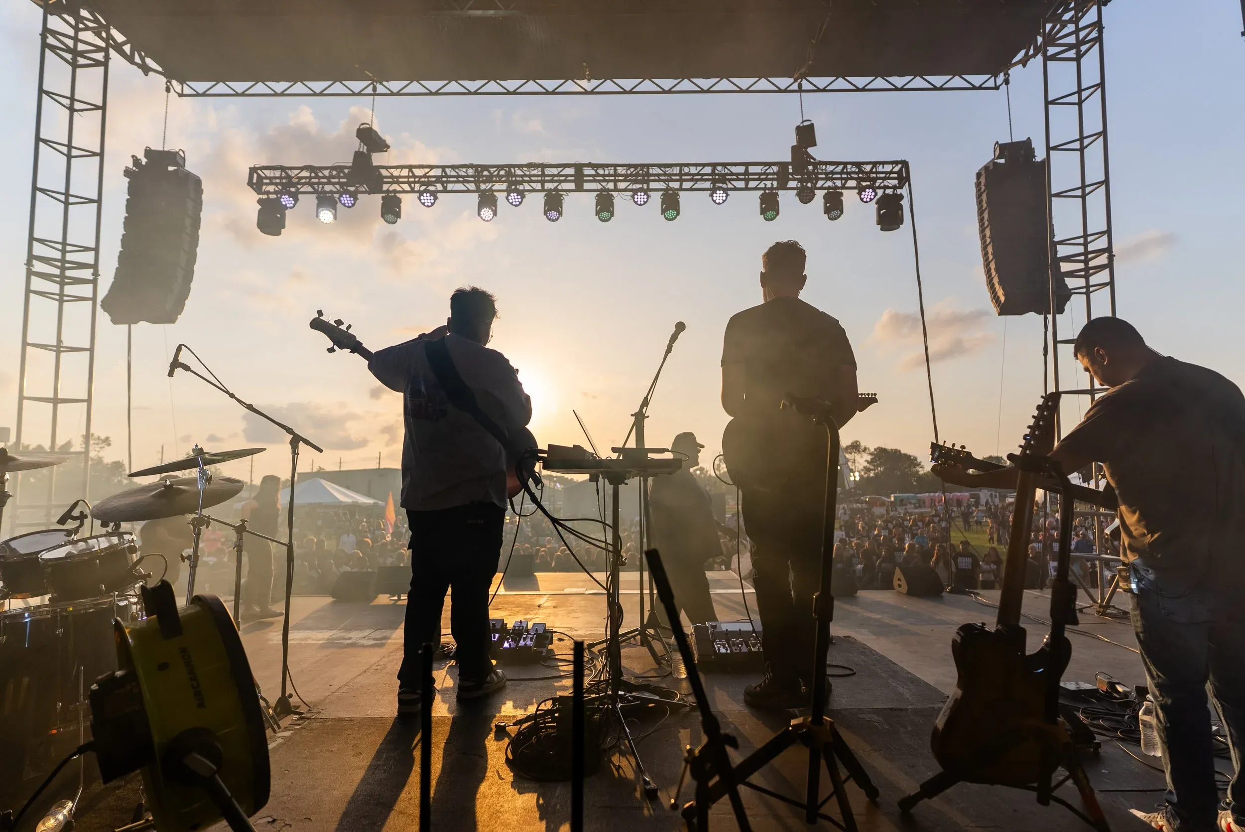 Worship band silhouetted against the sunset on the JESUS, JESUS, JESUS main stage