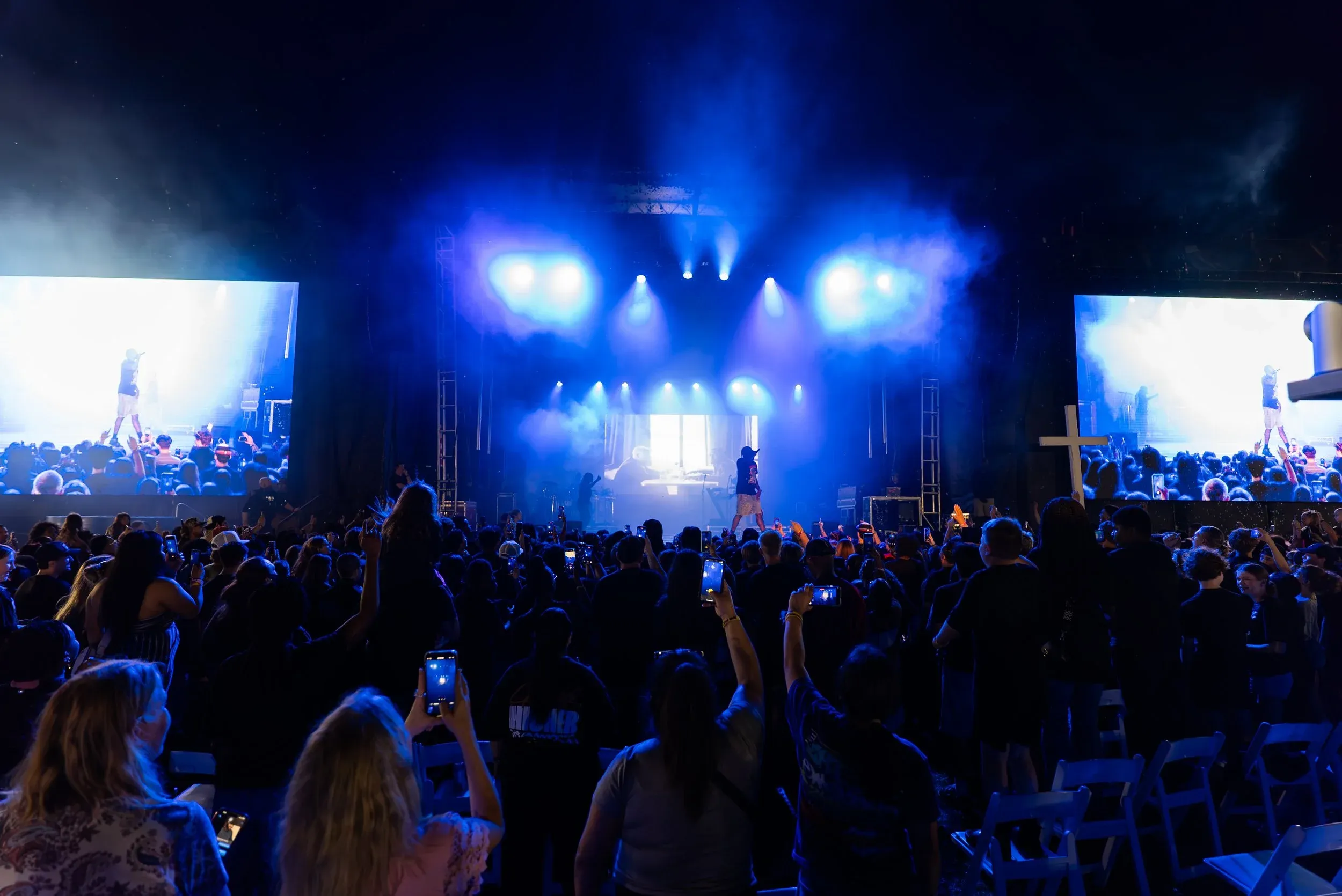 The stage and crowd under blue light at night