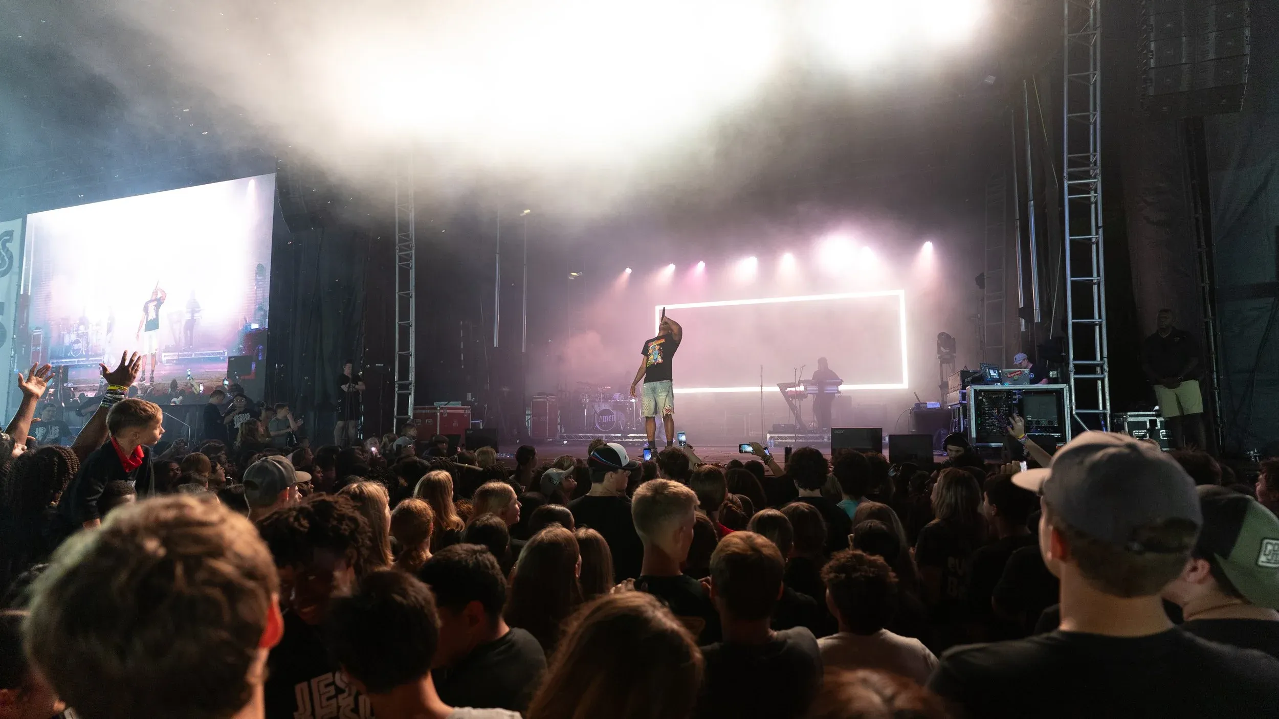 The crowd in worship under stage light at night